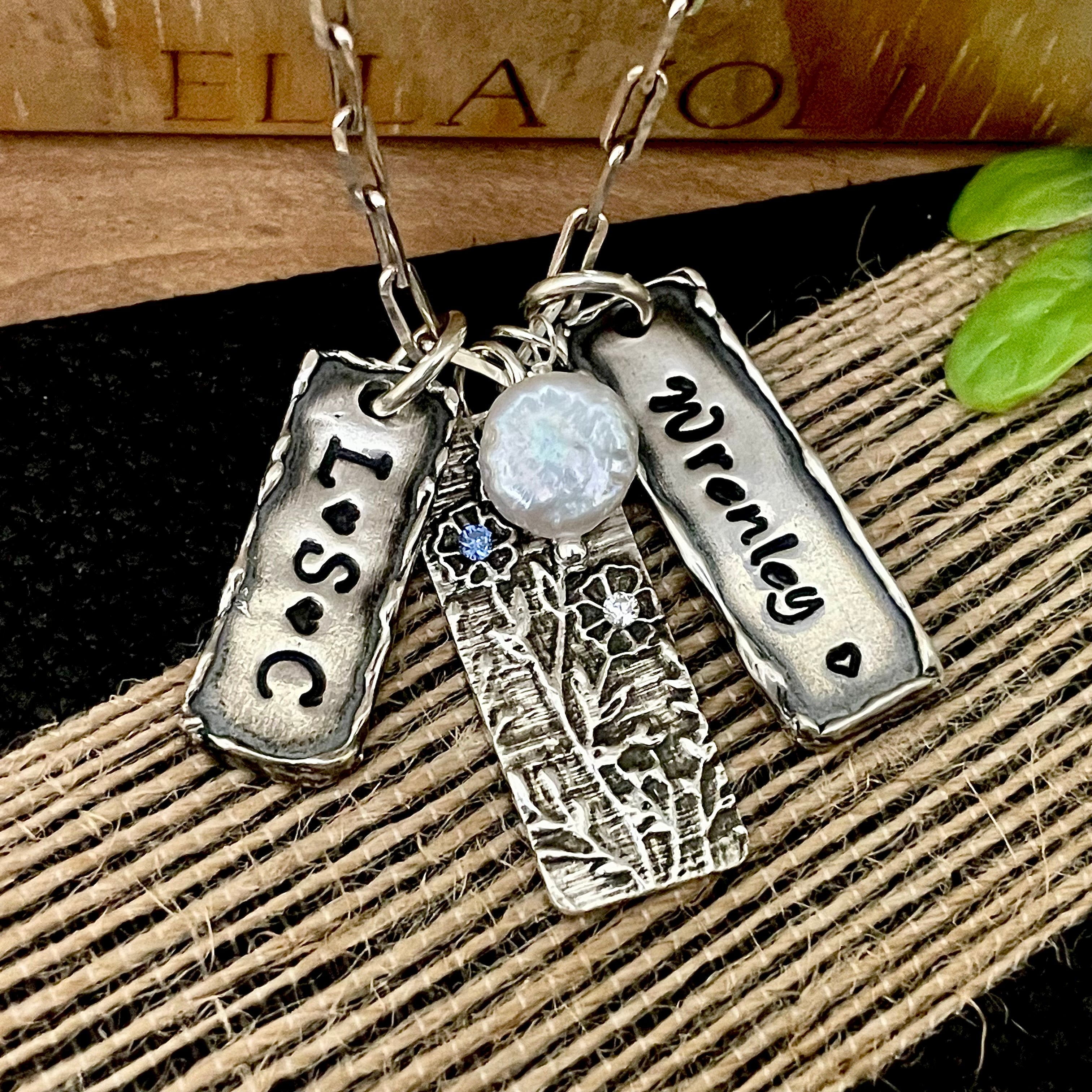 Handcrafted sterling silver women's necklaces featuring personalized name pendants, initial jewelry, floral birthstone pendant, and pearl charm — Ella Joli