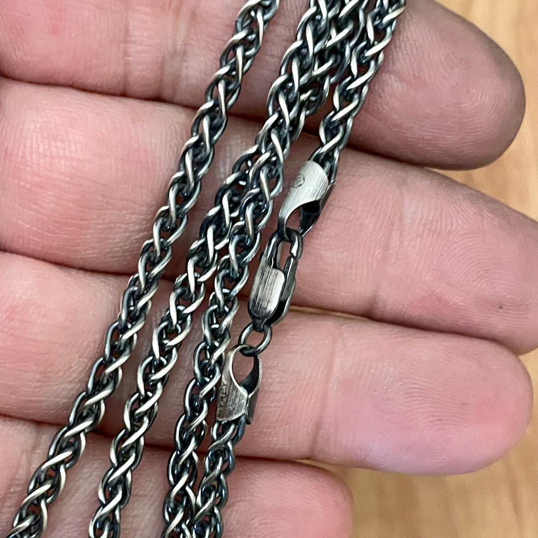 3.5mm 925 sterling silver wheat chain necklace oxidized for antique look and lobster clasp shown in hand. 