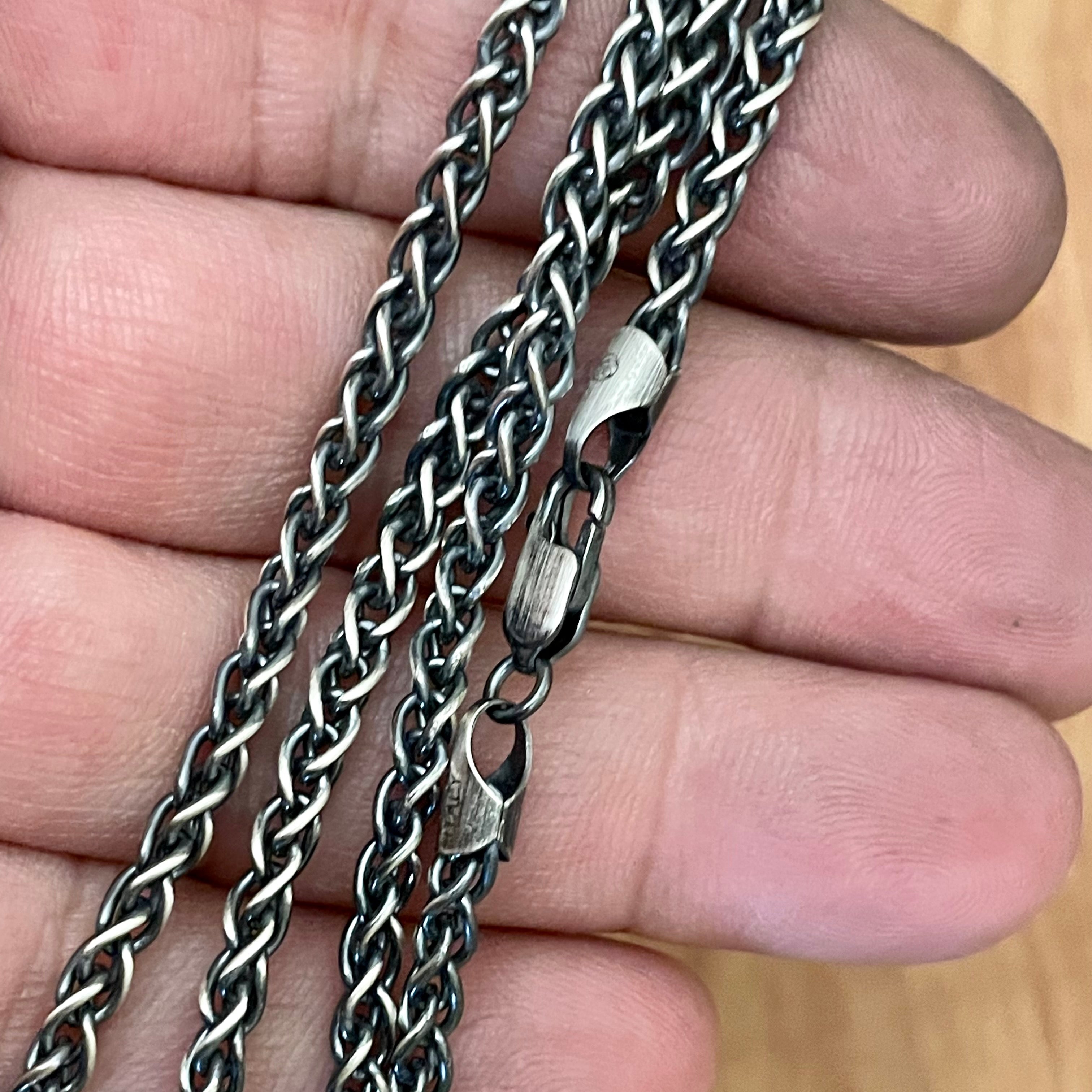 3.5mm 925 sterling silver wheat chain necklace oxidized for antique look and lobster clasp shown in hand. 