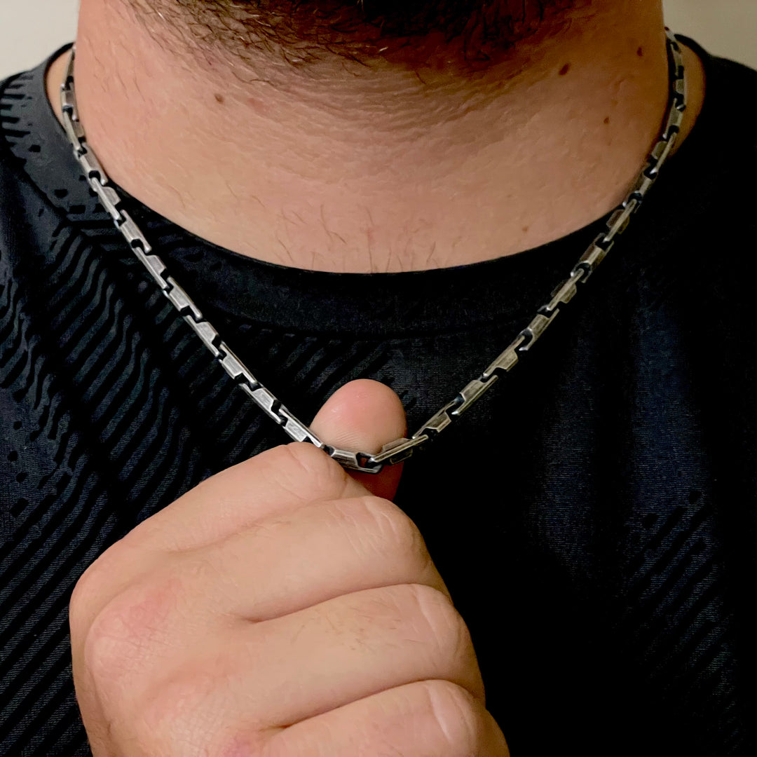 4.6mm sterling silver heshe bar link necklace shown worn on neck being held with finger 