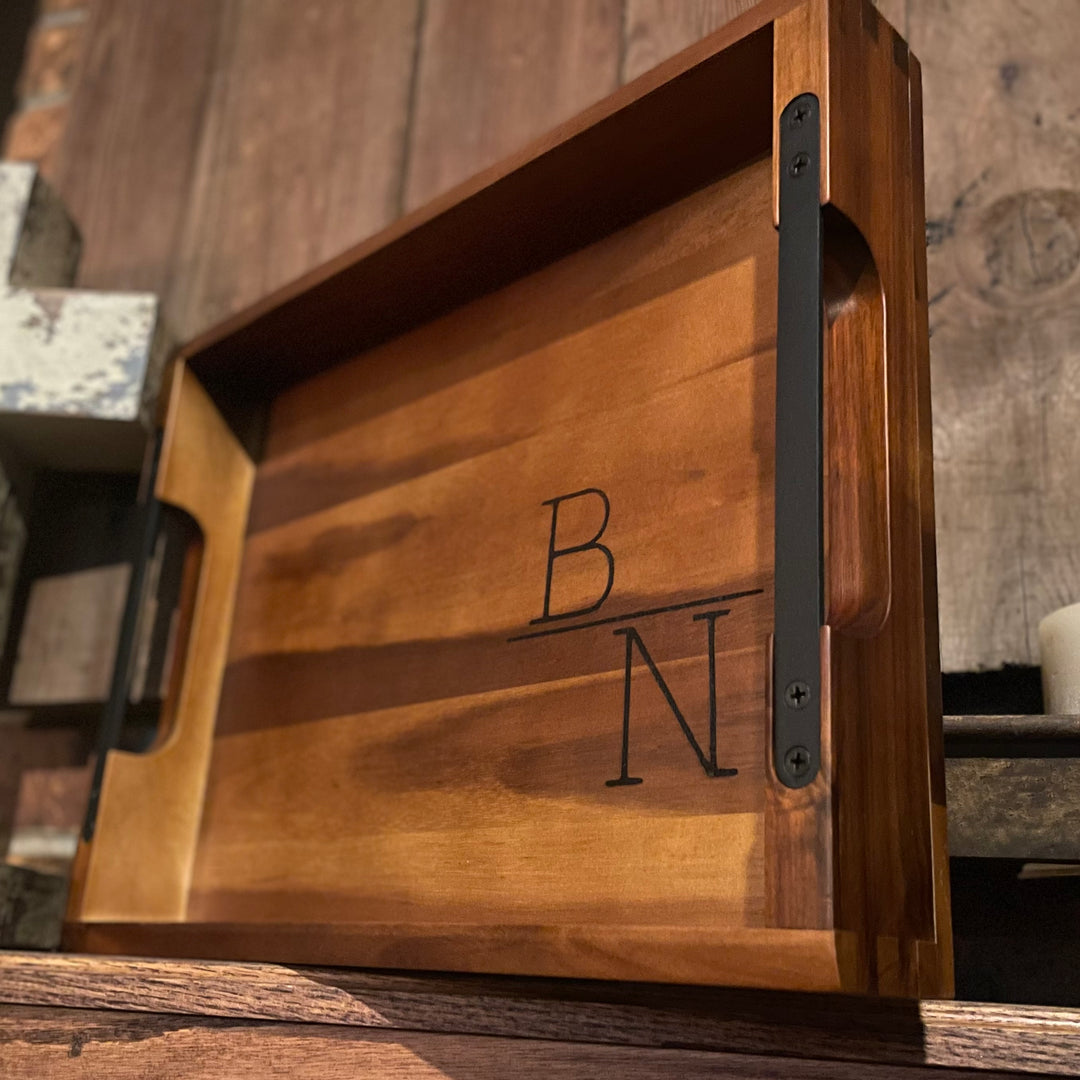 Personalized wood serving tray with metal handles. Shown with couples initials on wood shelf