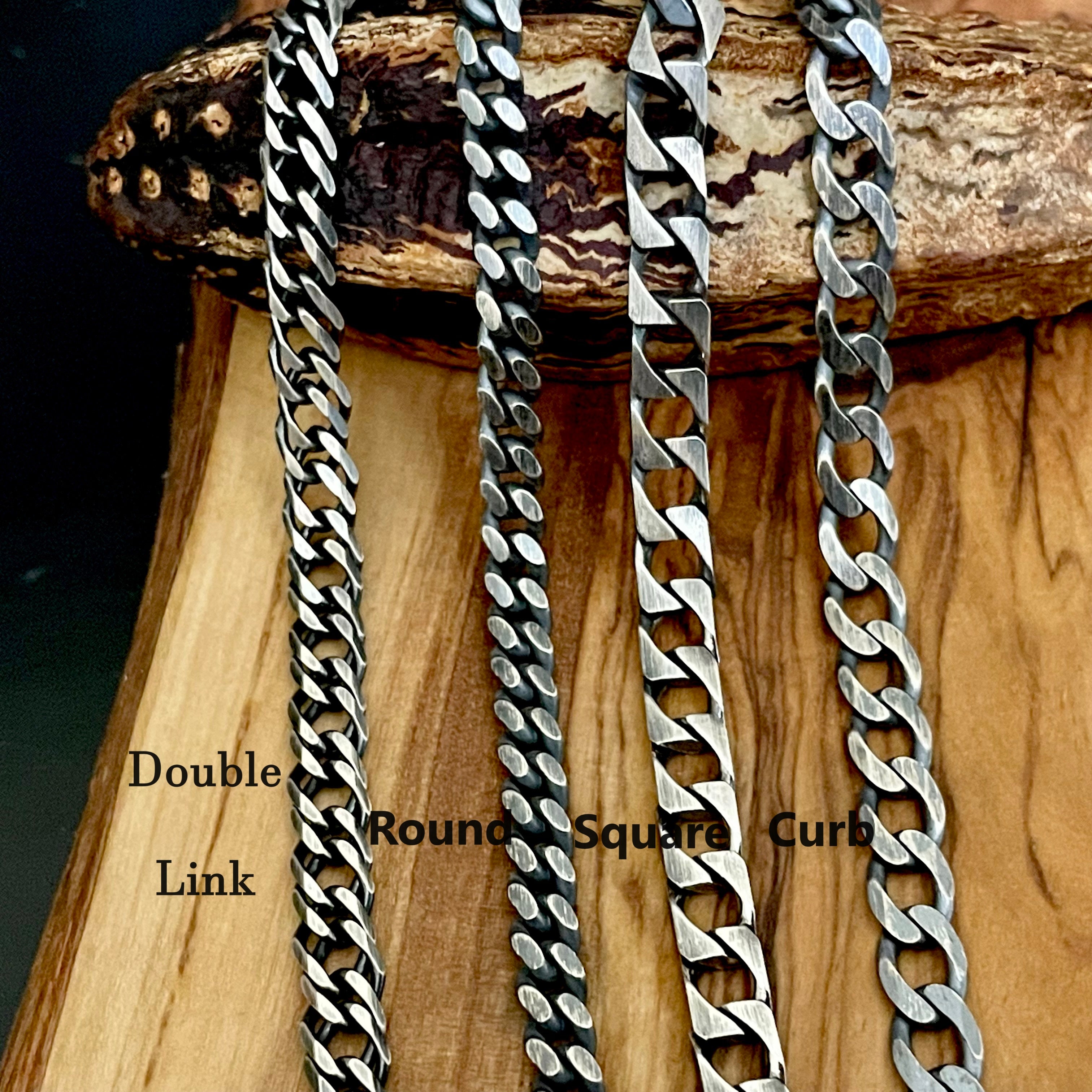Four different chain styles on a wooden block