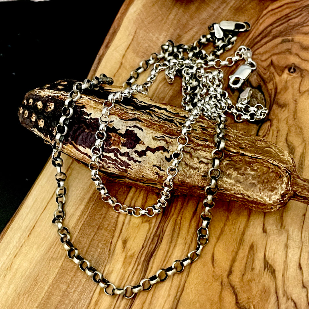 Sterling Silver Rolo Chains on wood background with lobster clasps. 