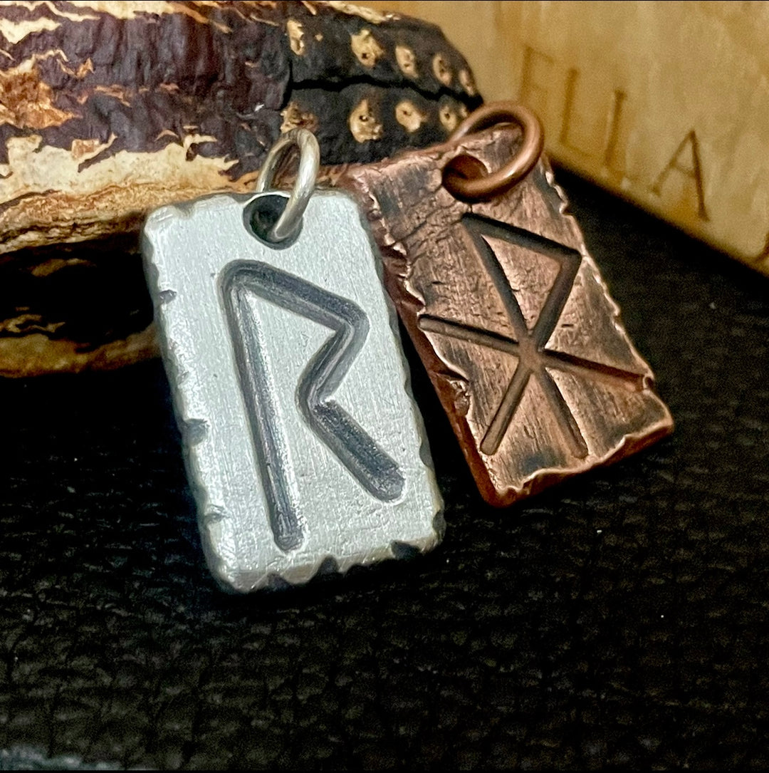 Hand forged and personalized custom 1 inch Viking room, elder futhark pendants. Shown with wood background