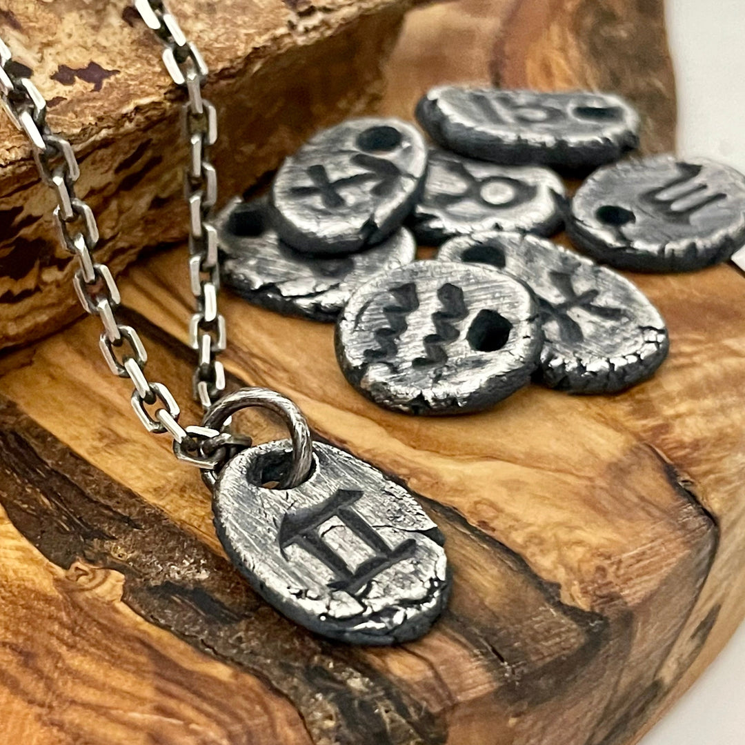 3/4" tall, thick, oxidized silver zodiac sign pendant charm on necklace with oxidized 2.7mm rectangle cable chain. Choose your sign. Shown on wood dispay with all of the zodiac symbols in background. 