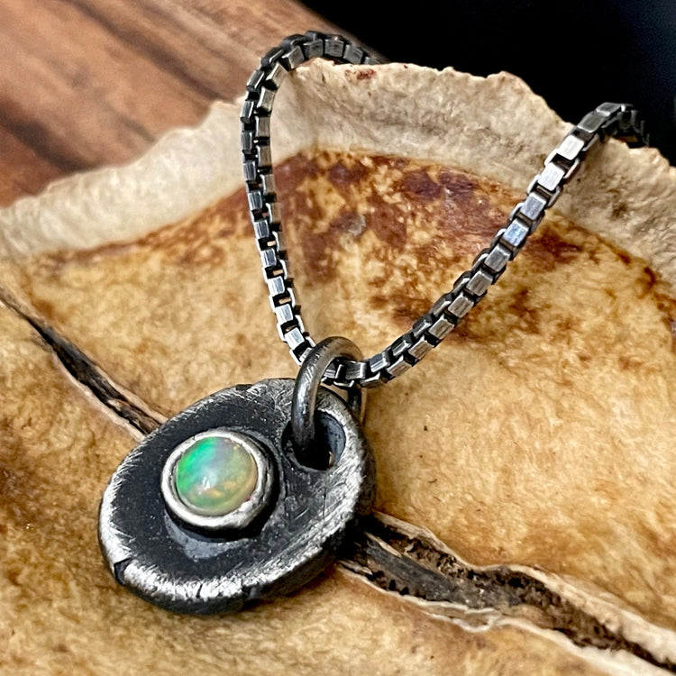 Mens Silver Fire Opal Pendant Necklace on wood background 