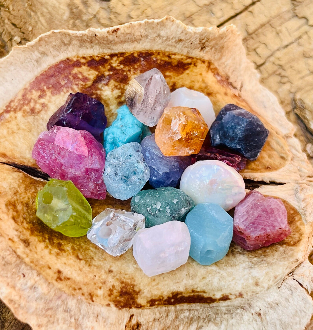 Assorted colorful crystals and gemstones on a natural wooden surface