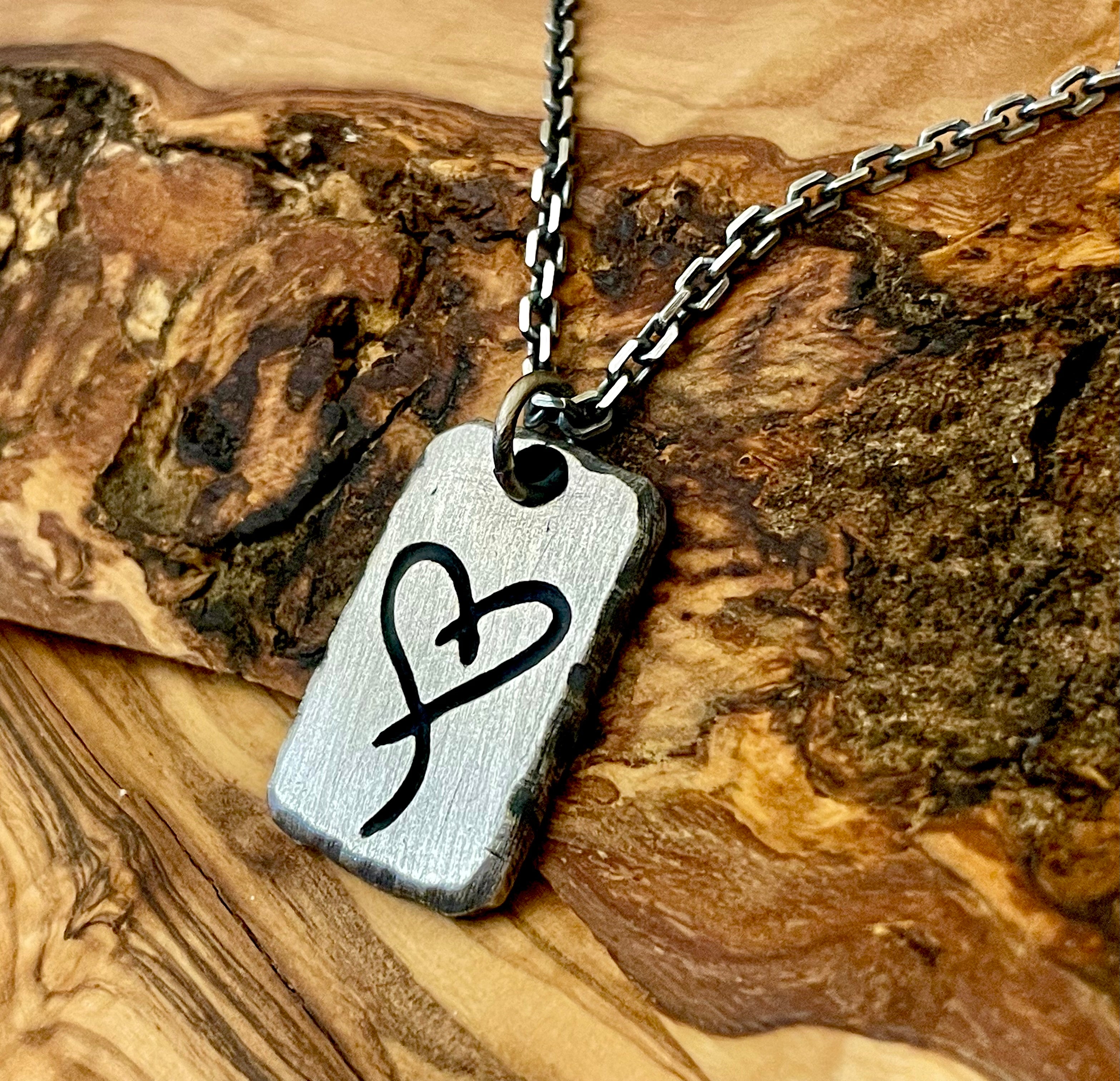 mens sterling silver necklace with tattoo image hand carved into surface photo shows a heart. Chain is optional