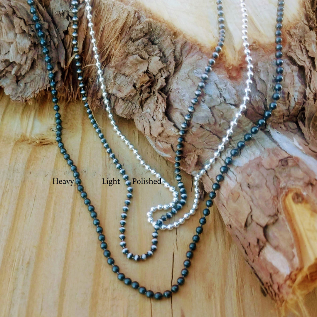 Sterling Silver Ball Chain | Silver Bead Necklace in three finishes of black, polished and oxidized displayed on wood.  