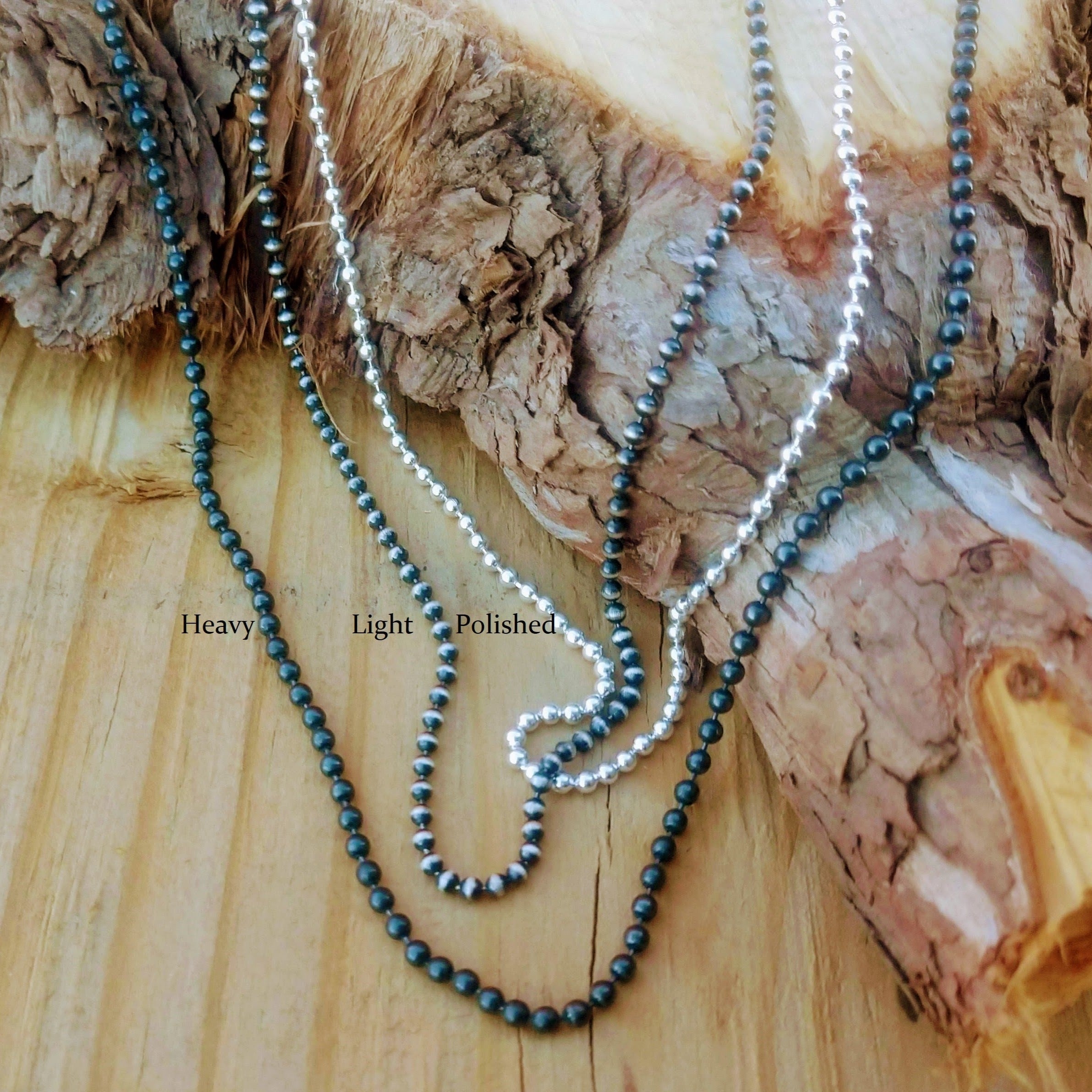 Sterling Silver Ball Chain | Silver Bead Necklace in three finishes of black, polished and oxidized displayed on wood.  