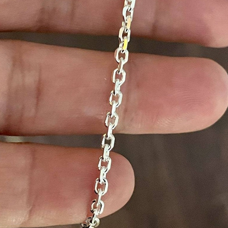 Polished 2.7mm sterling silver cable chain shown in hand. 