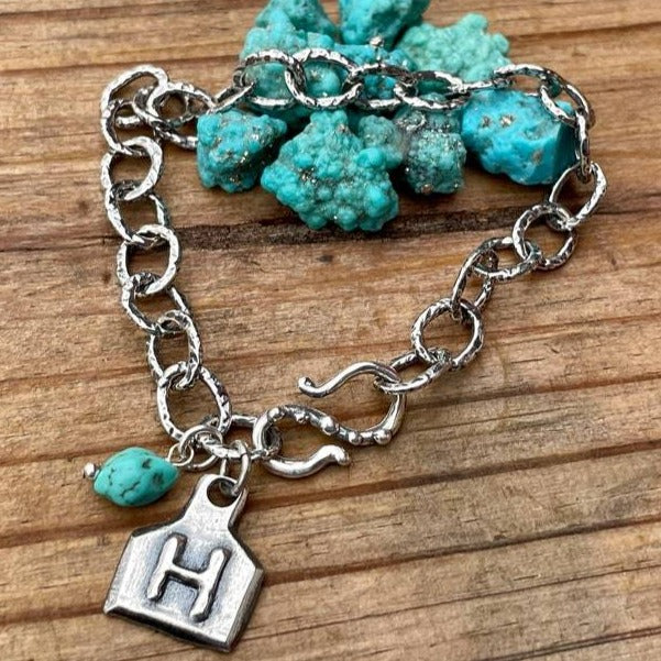 Custom ranch brand bracelet for women. Artisan hand crafted with cow ear tag charm custom made with your brand! Turquoise and Sterling Silver