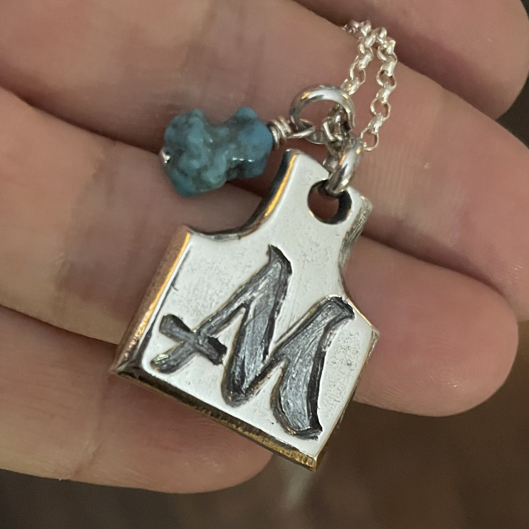 Sterling silver cow tag pendant with livestock brand