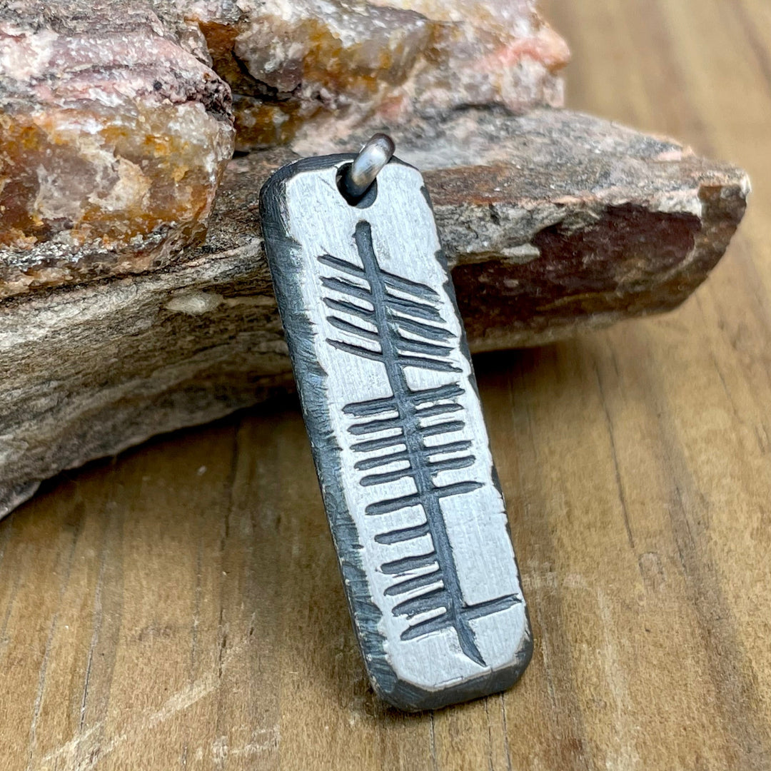 Sterling silver Irish Athair "Father" Necklace Pendant hand forged and carved on sterling silver rectangle pendant. Shown on wood. 