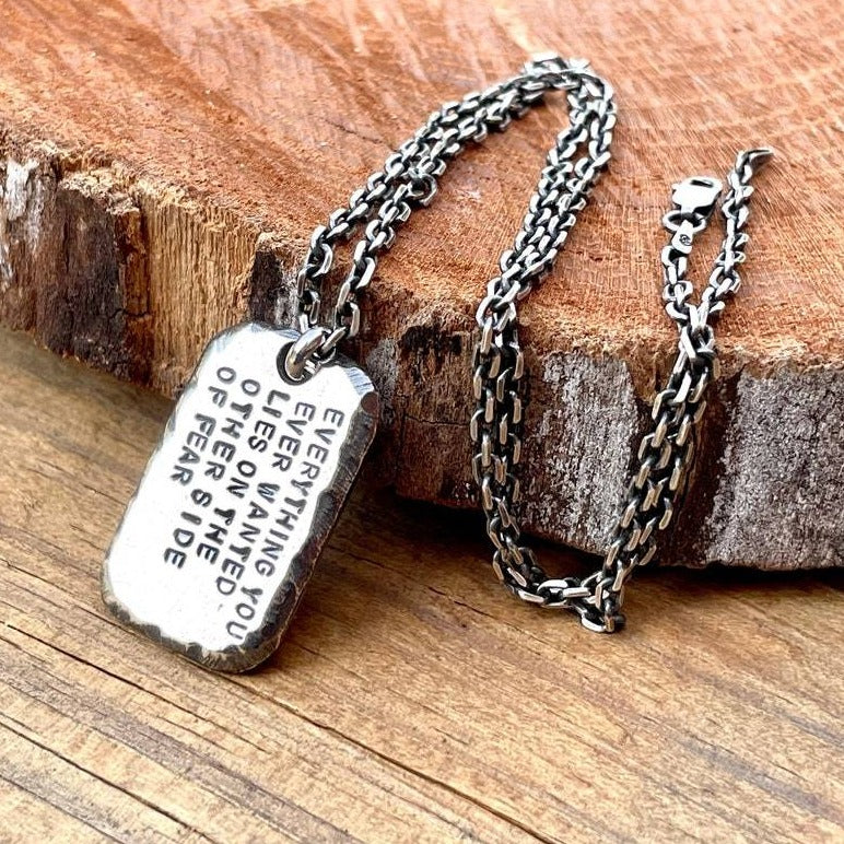 A one inch silver rectangle shaped pendant hanging from 2.7mm oxidized sterling silver rectangle link cable shown. Shown on wood background.