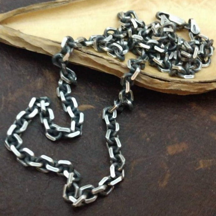 Solid 4x5mm sterling silver beveled cable chain necklace oxidized or polished elongated link. Shown on wood display. 