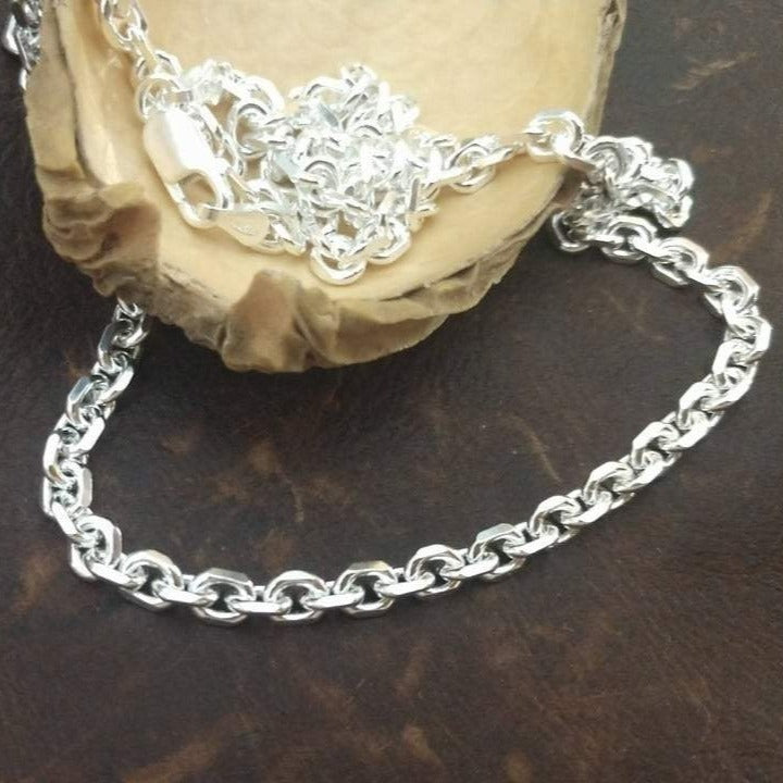 Solid 4x5mm sterling silver beveled cable chain necklace oxidized or polished elongated link. Shown on wood display. 