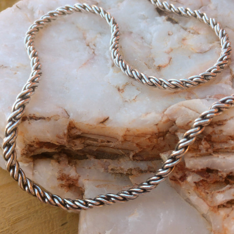 3.6mm sterling silver reverse rope chain necklace displays on stone
